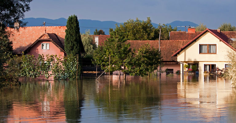 Houses flooded with water up to their first floors.