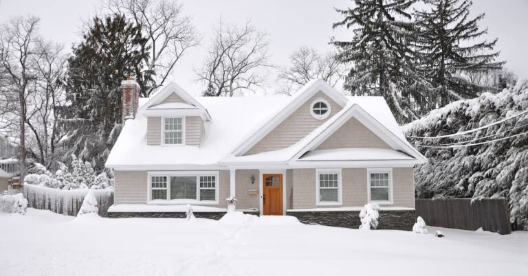 Home covered in snow from winter storm | ATI Restoration