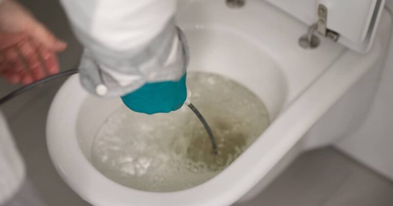 Professional repairing overflowing toilet | ATI Restoration